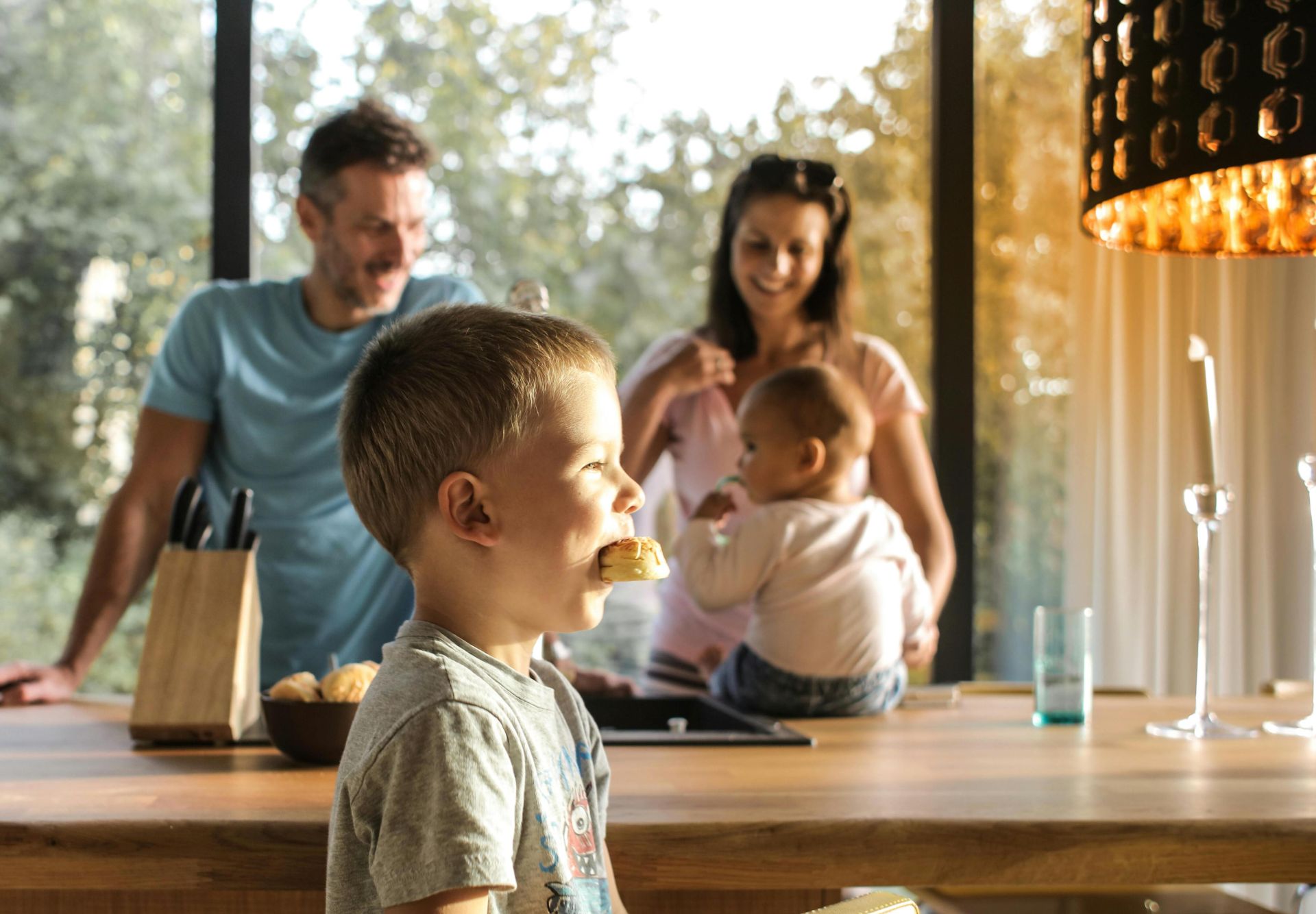 A joyful family gathers in a bright kitchen, enjoying breakfast and togetherness.